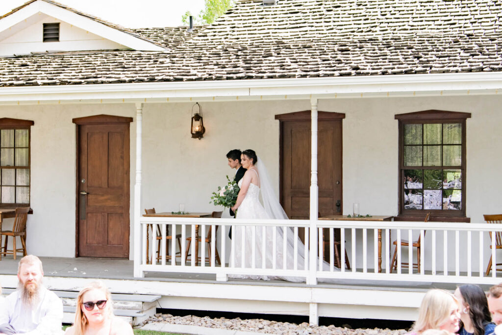 Bride being walked to the ceremony on a porch