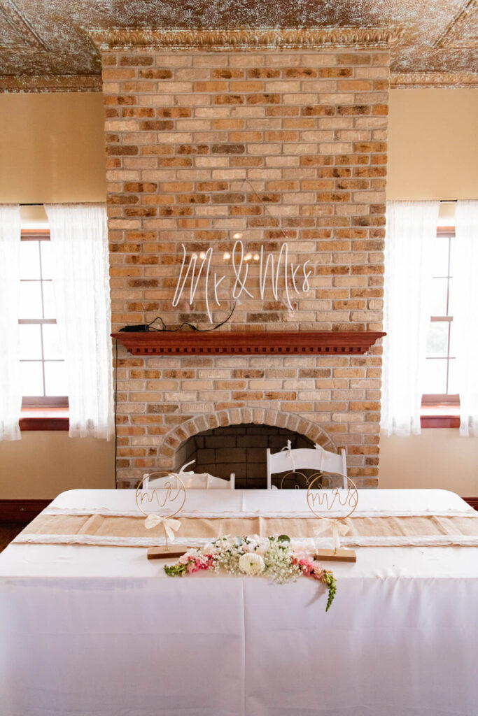 A fireplace with the bride's table in front