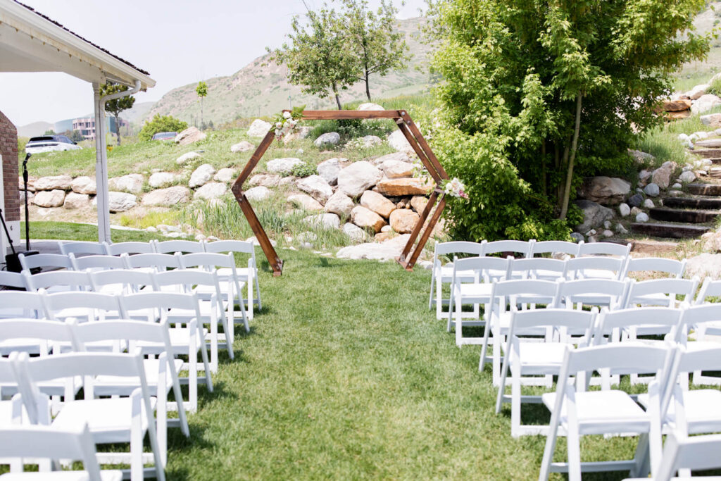 A ceremony space outside with a hexagon flower arch