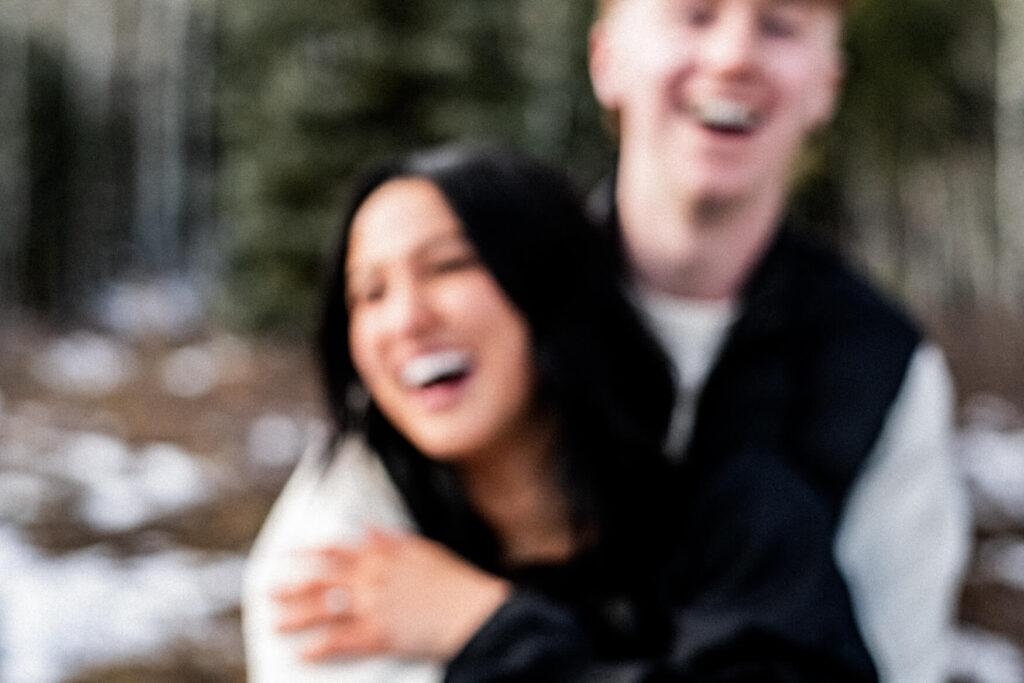 blurry photo of a man and woman laughing.