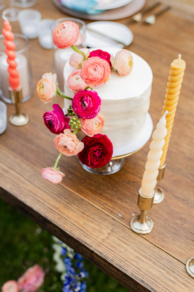 Flowers on a cake surrounded by candles.