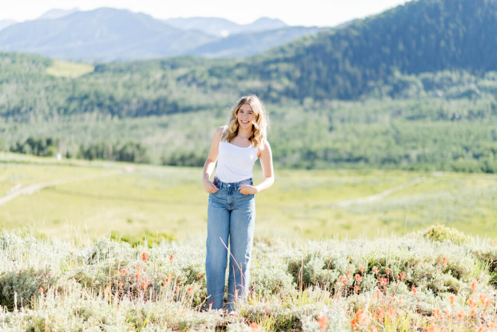 Girl with her hands in her pockets in a large meadow