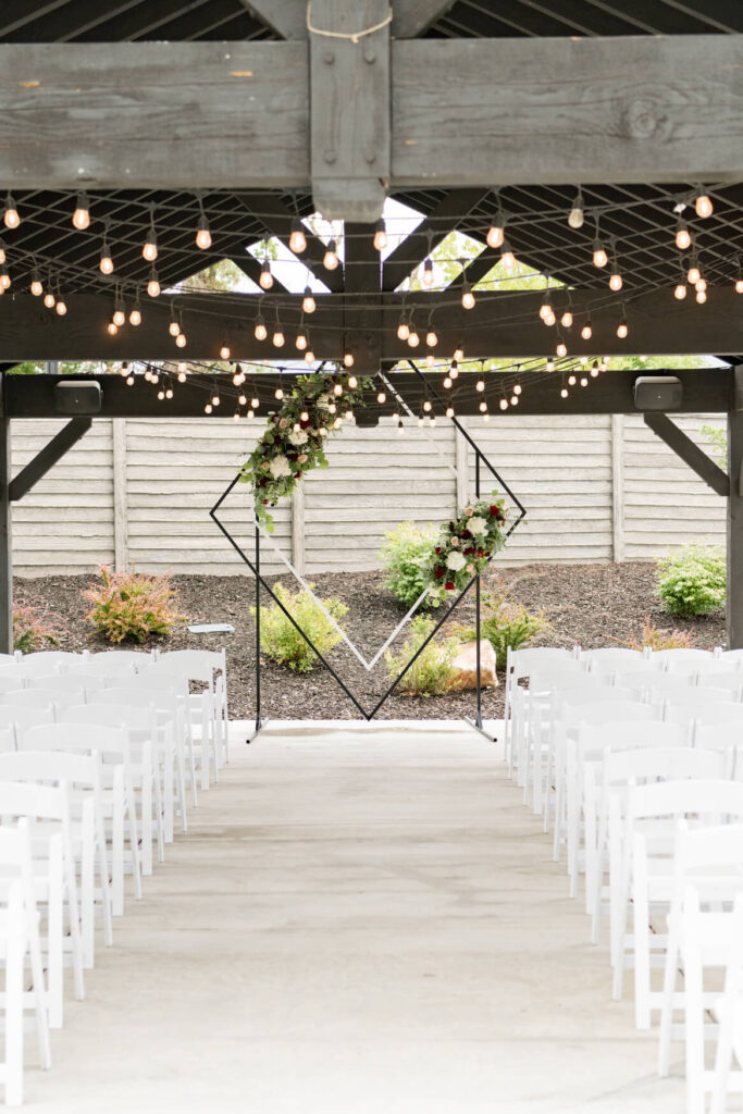 Closer view of the arch and chairs set up for a wedding ceremony