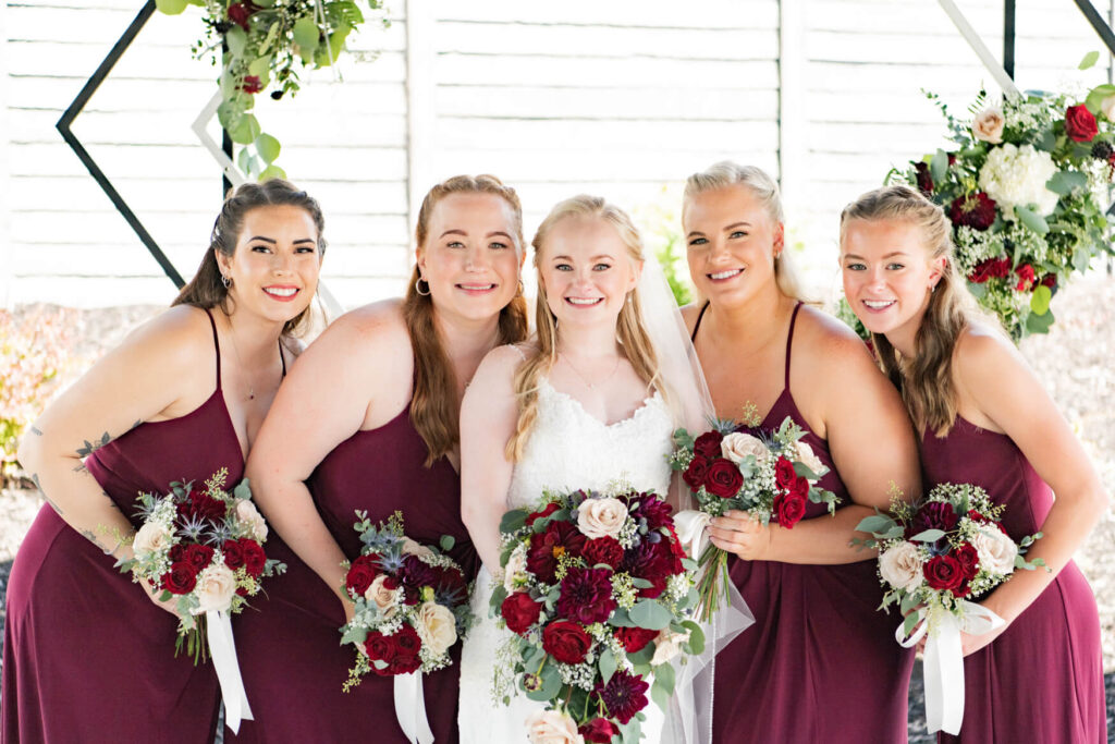 Bride and bridesmaids standing close together for a picture