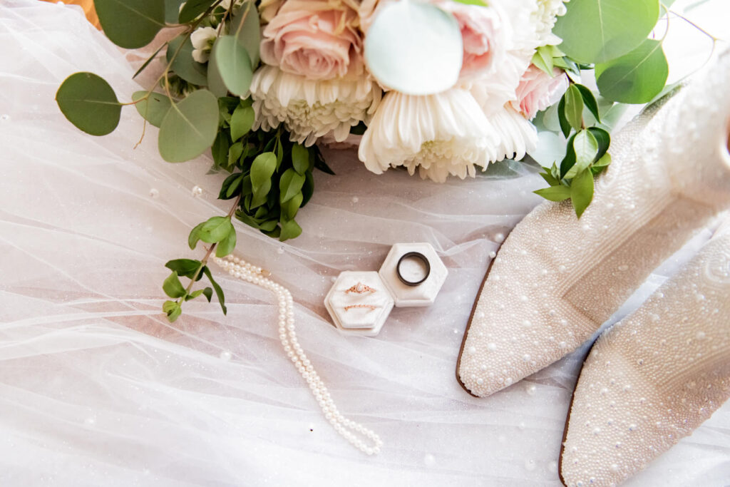 Flat lay setup with flowers, shoes, veil, etc.