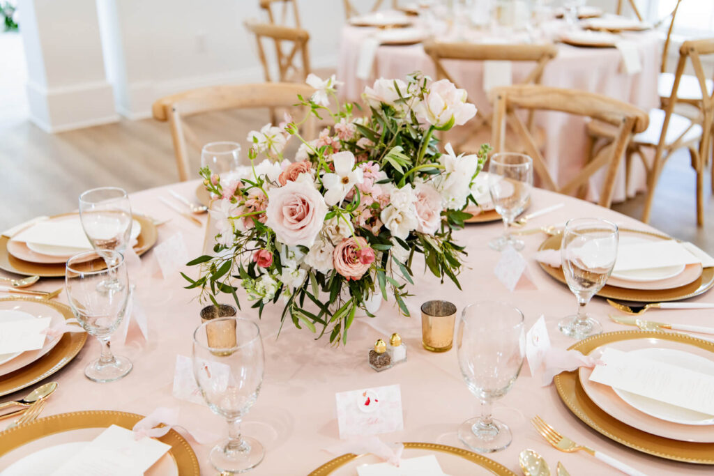 Blush and sage flower arrangement on a reception table